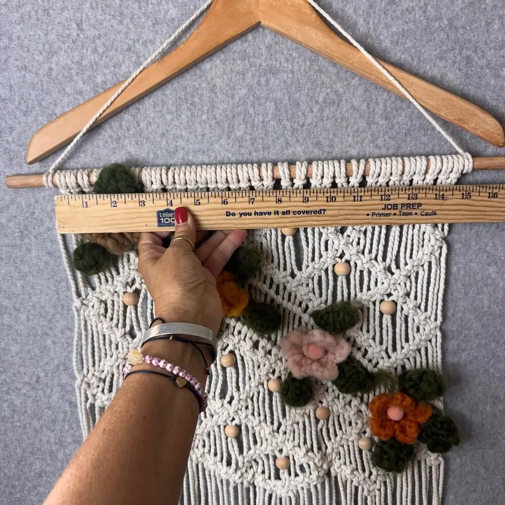 handmade boho-style macramé wall hanging crocheted flowers wooden beads fringe